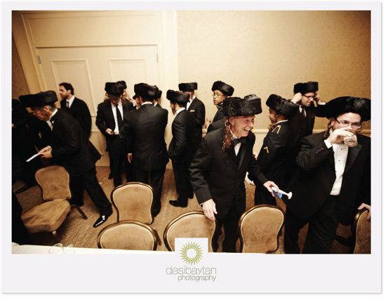 Men in traditional Jewish attire at a wedding