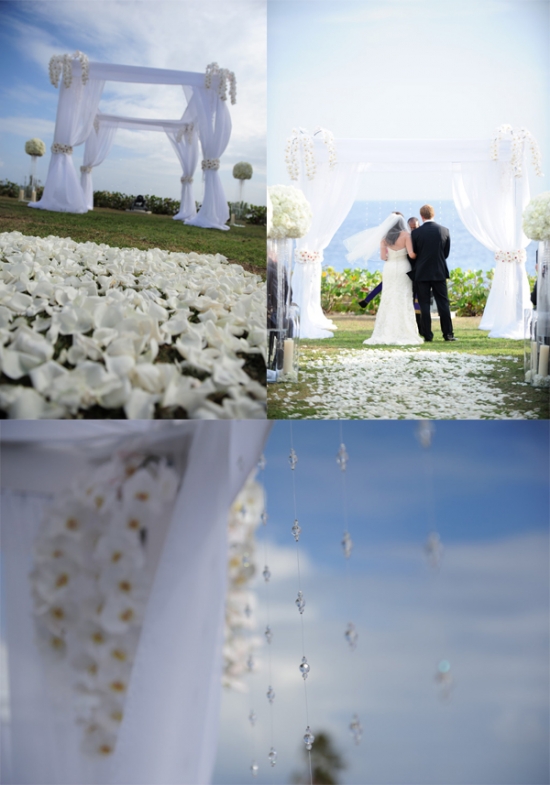 Elegant beach wedding ceremony setup with white flowers