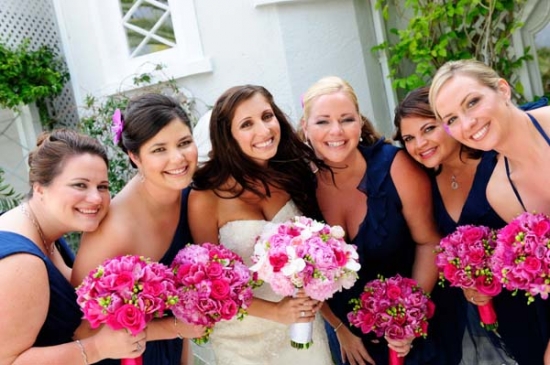 Bridesmaids smiling, holding pink bouquets