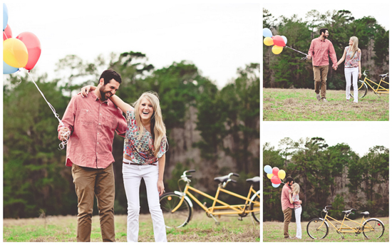A couple kisses next to a yellow tandem bike with bright balloons.