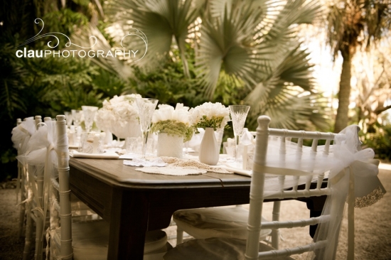 Outdoor wedding reception table setting with white decor