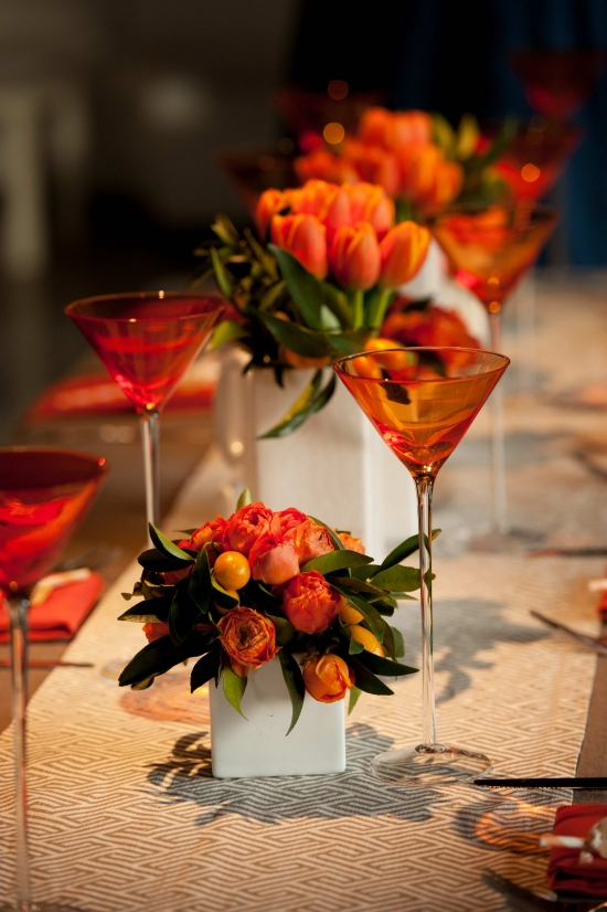 Elegant tablescape with orange flowers and martini glasses