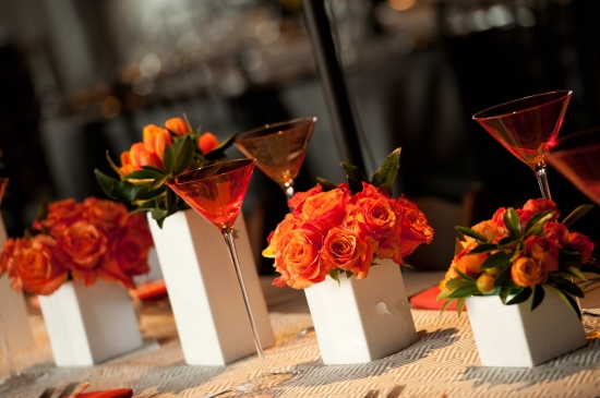 Orange flowers and cocktails on a table setting