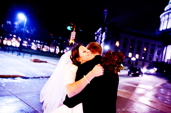 Happy couple embraces at night wedding