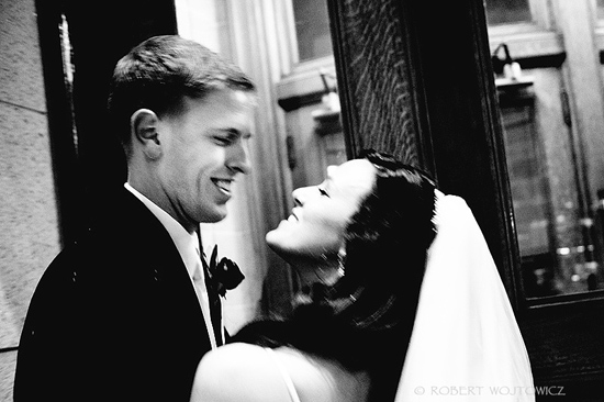 Black and white photo of a bride and groom embracing