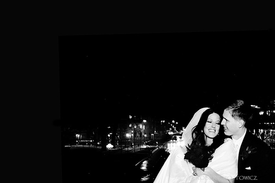 Happy couple embracing at night, city lights in background