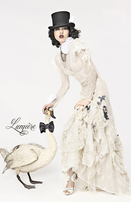 Elegant woman in top hat and lace gown with swan