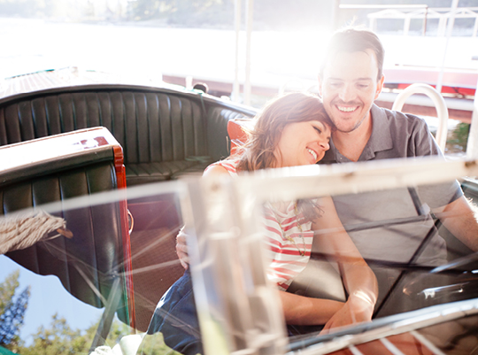 Happy couple cuddling on a boat ride