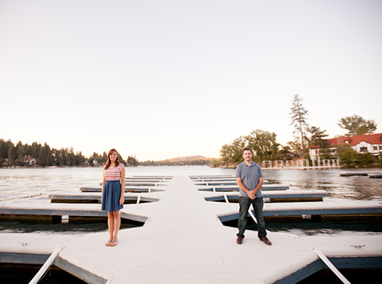 Couple standing on a lake dock