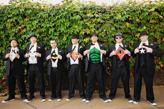 Groomsmen in suits reveal superhero logos