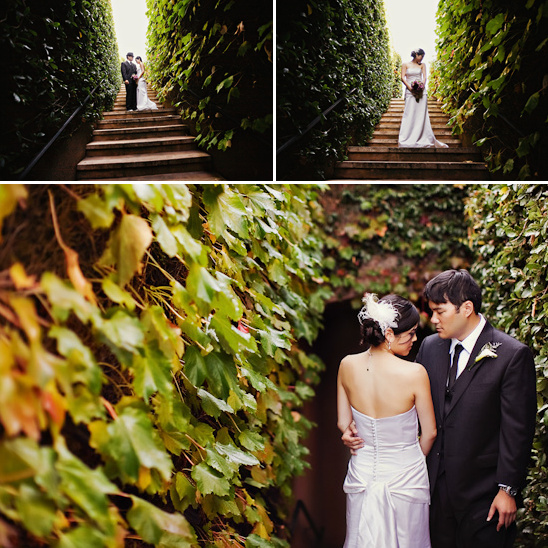 Romantic wedding couple posing by ivy walls
