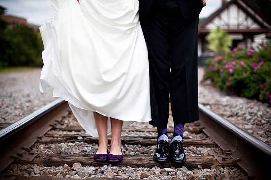 Bride groom with fun socks on railroad tracks