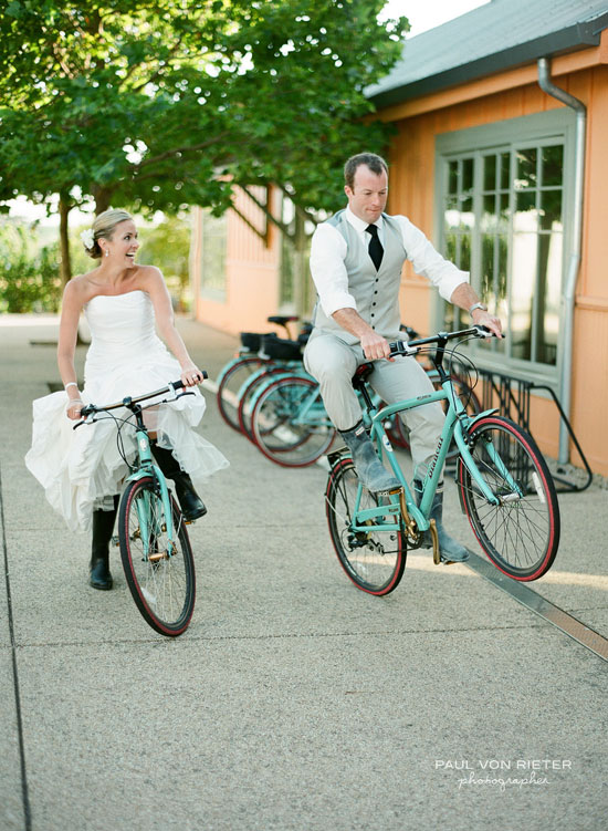 Bride and groom riding bikes on wedding day