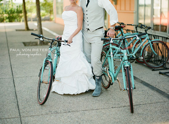 Bride and groom with vintage turquoise bicycles