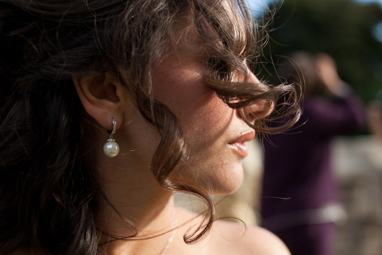 Woman with curly hair and pearl earring side profile