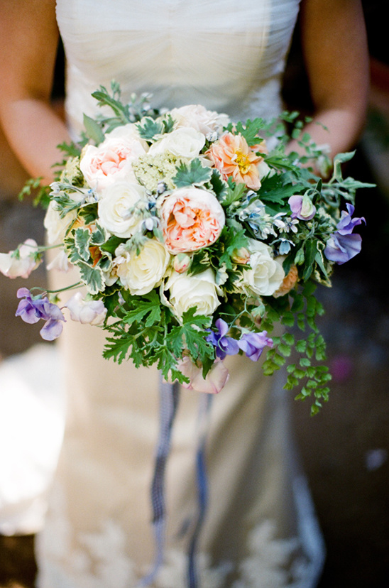 Bridal bouquet: pastel roses, greenery, and wildflowers