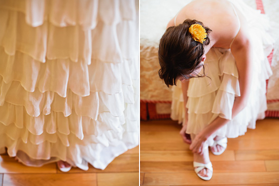 Bride puts on her white ruffled wedding dress shoes