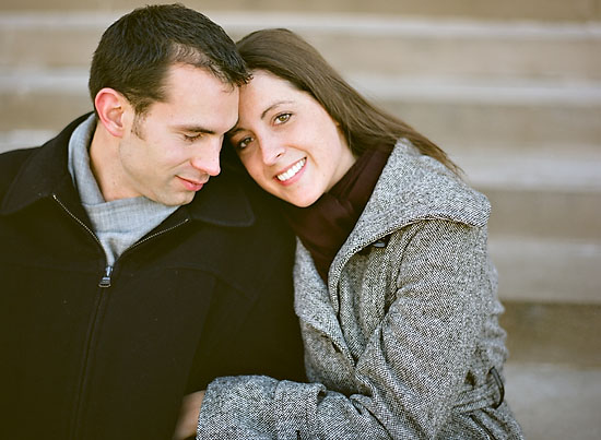 Romantic couple embracing on steps, showing affection