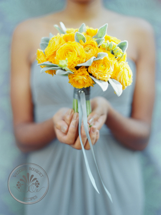 Yellow flower bouquet held by hands