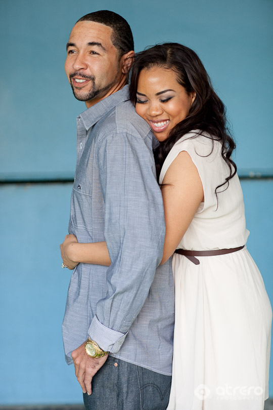 Happy couple embracing, a man and a woman, blue background