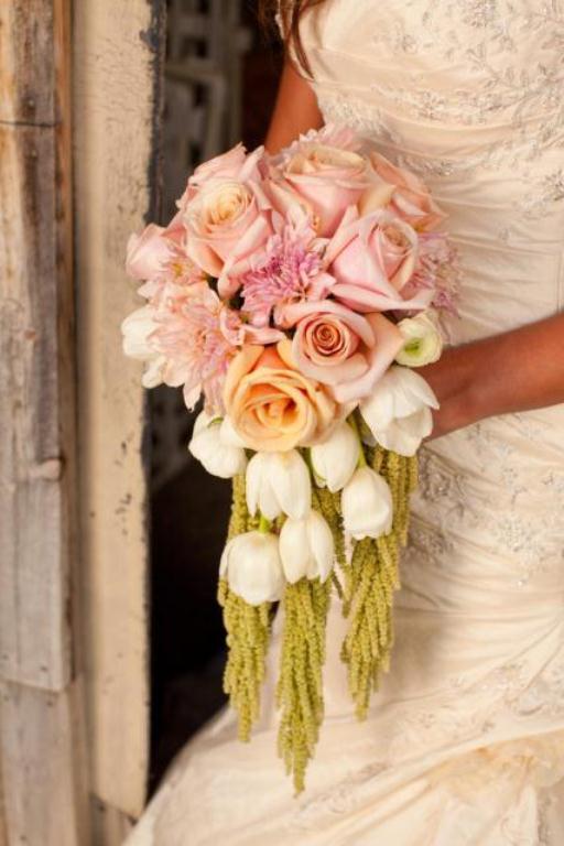 Elegant cascading bridal bouquet with roses and tulips