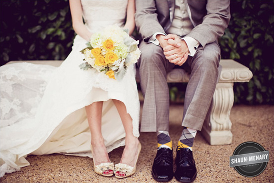 Bride and groom sitting showing socks and shoes