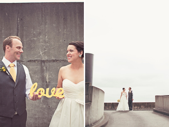 Wedding couple smiles and holds a yellow love sign, a beautiful moment