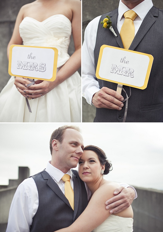 Elegant wedding couple with Mr and Mrs signs and joyful smiles