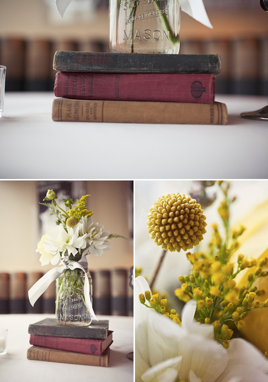 Wedding table decor with books and mason jar flowers