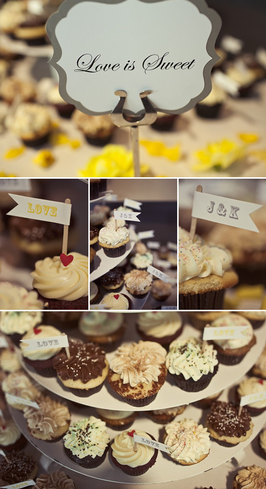 Wedding cupcakes with a love is sweet sign on display