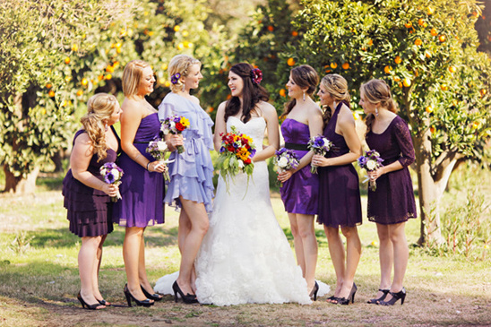 Bride with Bridesmaids in Purple Dresses Outdoors
