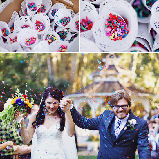 Bride and groom showered with confetti at wedding party