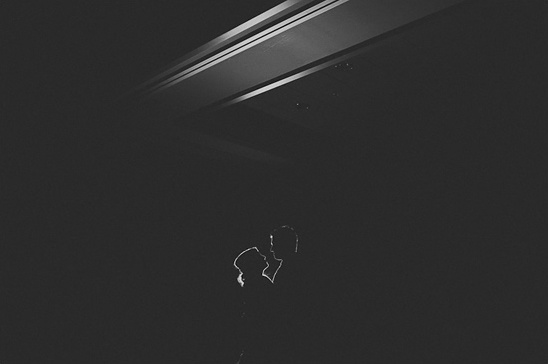 Silhouetted couple embracing in the darkness