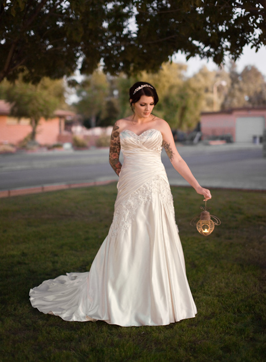 Bride in wedding dress holding lantern