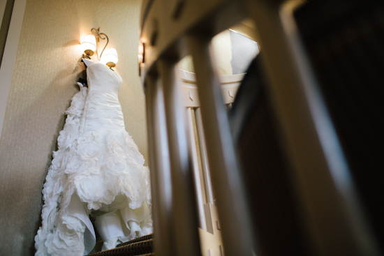 Elegant wedding dress hanging on wall, ready for the special day
