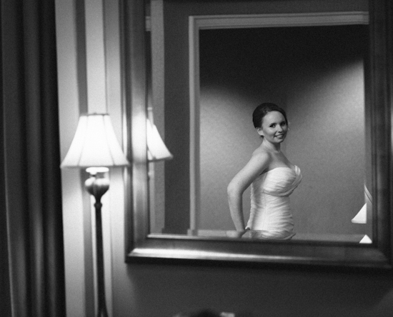 Bride admiring herself in the mirror before her wedding