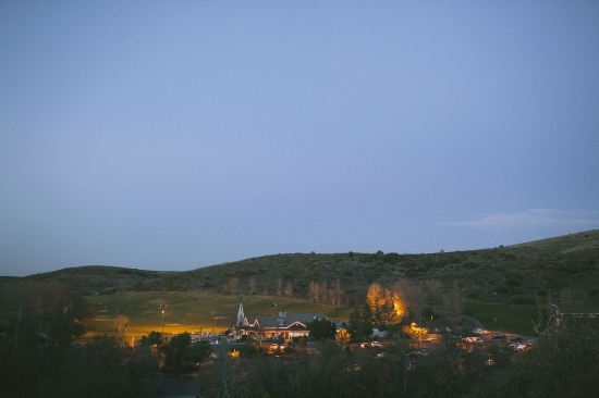 Dusk over the mountain village with illuminated buildings and trees