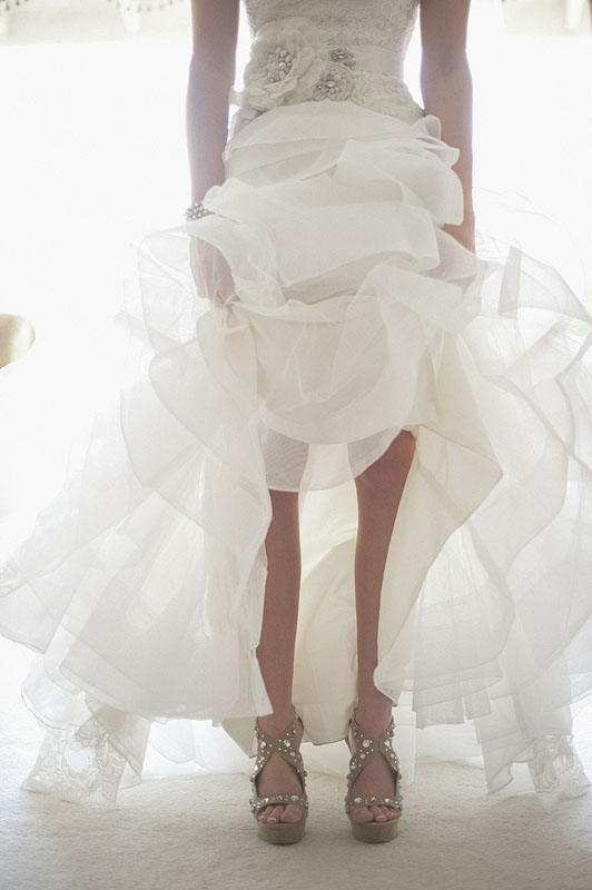 Bride in ruffled gown showing platform wedding shoes