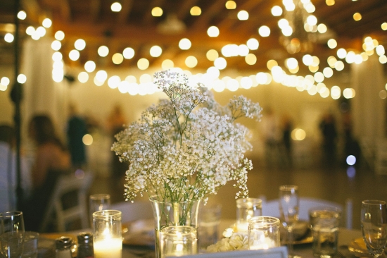 Elegant wedding reception with fairy lights and floral centerpiece