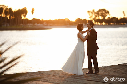 Couple dancing on a dock at sunset  Wedding photography concept