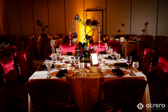Elegant wedding reception tables decorated with burgundy accents