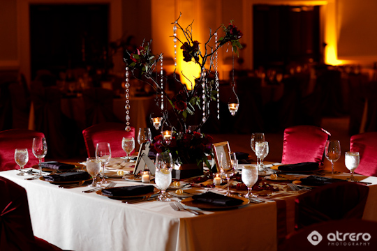 Elegant wedding table setting with dark red theme and decor