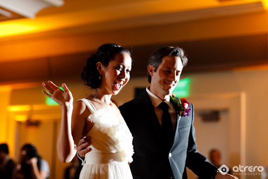 Excited bride and groom celebrating at their wedding reception