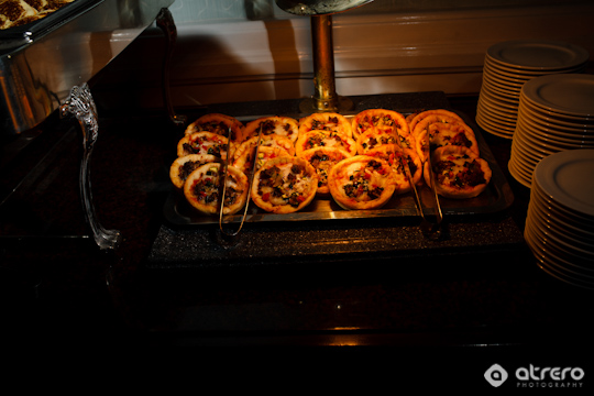 Mini pizzas on a serving tray, ready to be served at the buffet