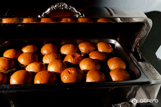 Freshly baked burger buns inside a warming buffet tray