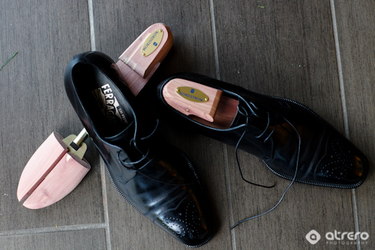 Elegant black Ferragamo shoes with cedar shoe trees for storage