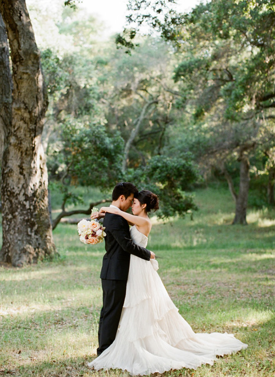 Romantic wedding couple embracing in a forest
