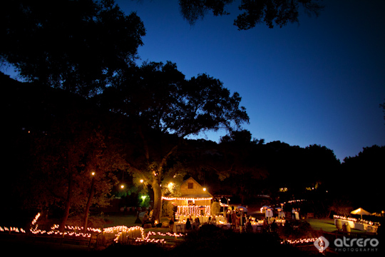 Nighttime outdoor wedding reception with candle lighting