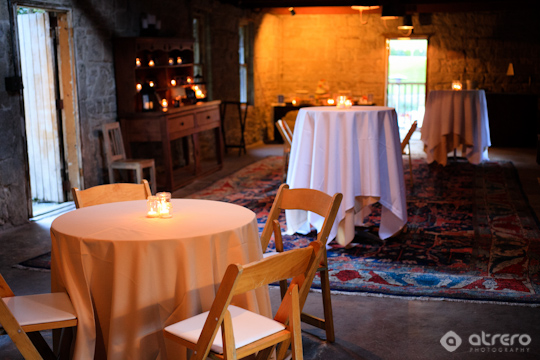 Cozy candlelit venue with tables and chairs for an event