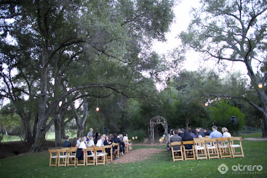 Outdoor wedding ceremony in garden setting with guests